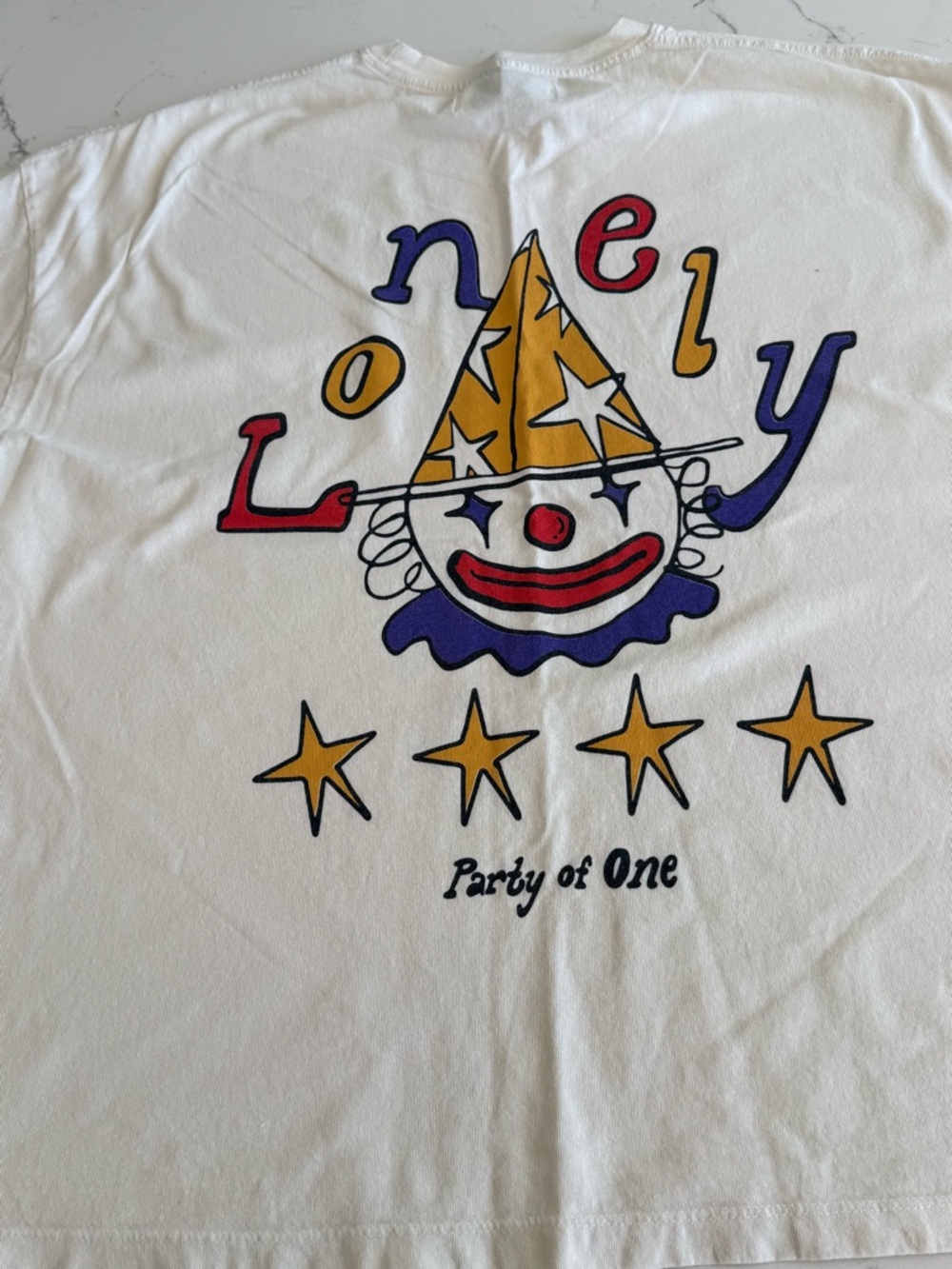 LONELY GHOST White Graphic Tee with Yellow, Red & Blue Clown Print
